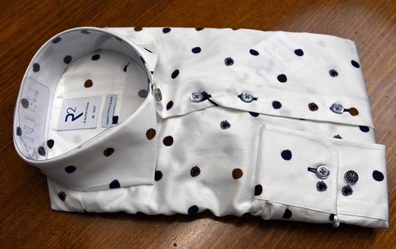 R2 shirt with small brown and blue spots on white