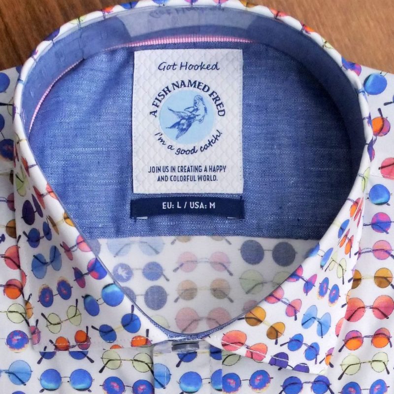 A Fish Named Fred shirt with rows of tiny sunglasses on white cotton. From Gabucci Menswear Bath