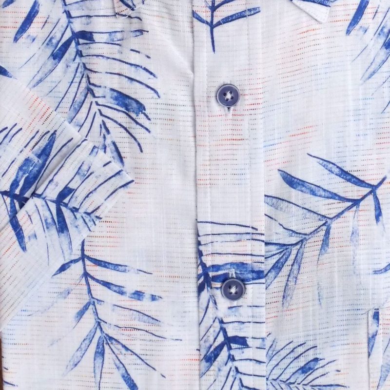 Giordano shirt with blue ferns on a faint red and blue pattern on white.