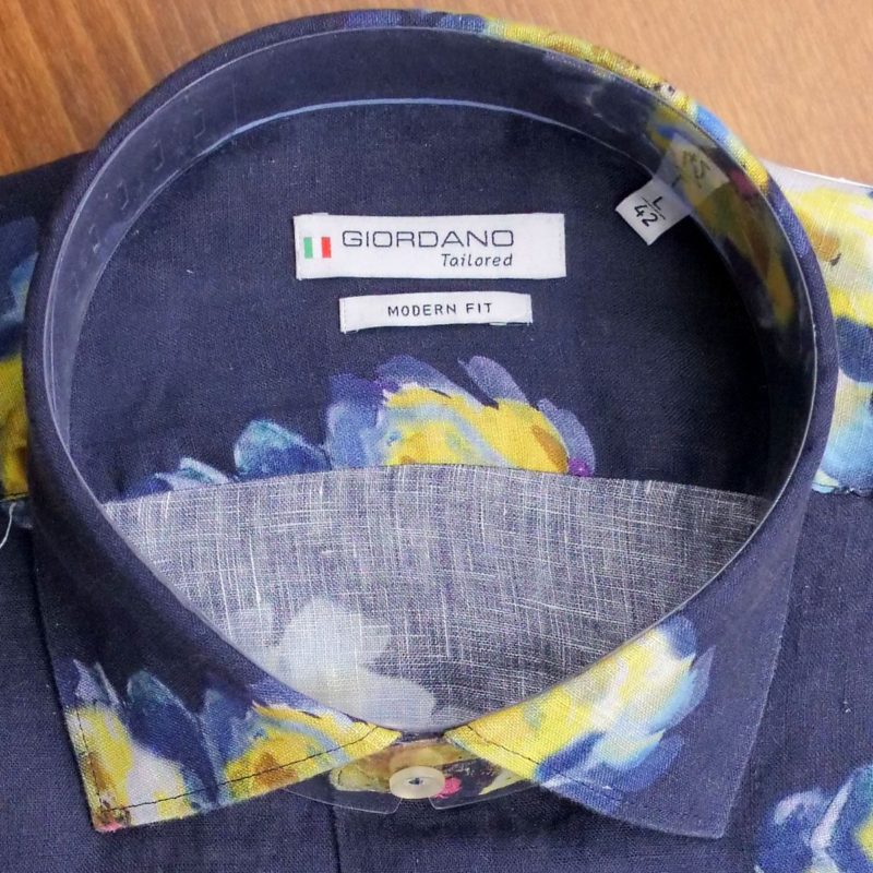 Giordano shirt with blue and yellow flowers on dark blue