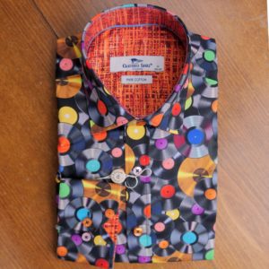Claudio Lugli shirt with colourful record design on black with a patterned orange lining. From Gabucci Menswear Bath