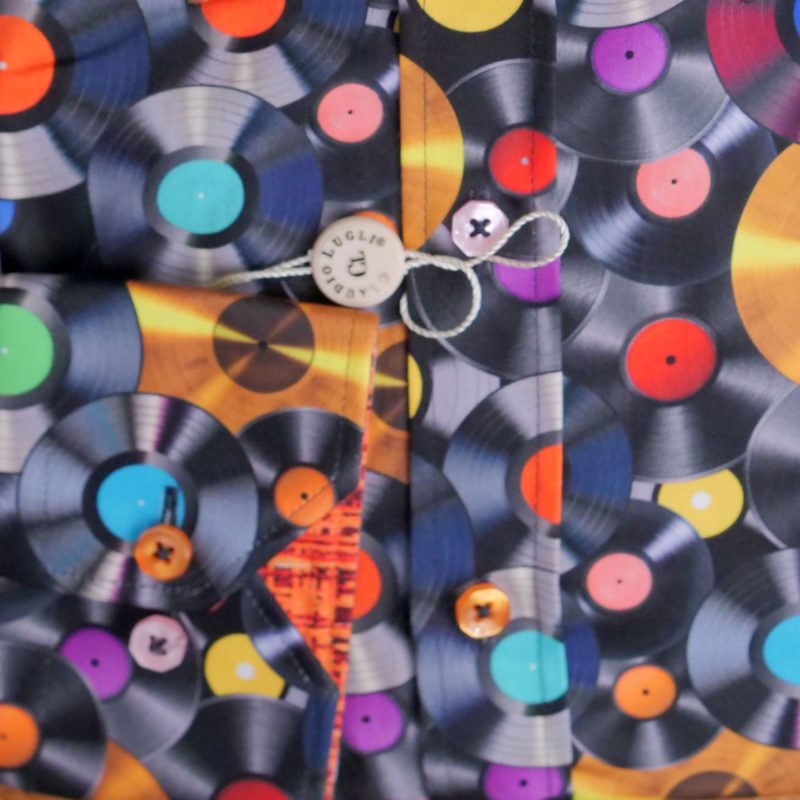Claudio Lugli shirt with colourful record design on black with a patterned orange lining. From Gabucci Menswear Bath