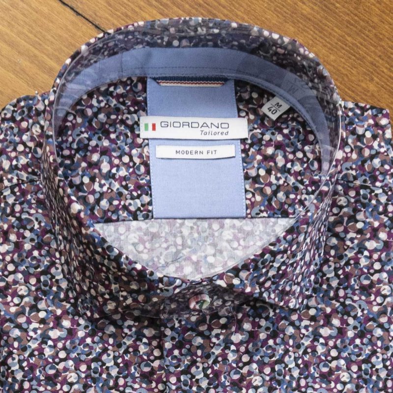 Giordano shirt with small blue and red circles on a dark background