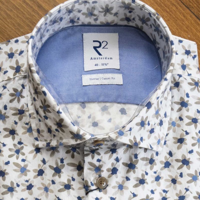 R2 shirt with small blue and brown flowers on a white background