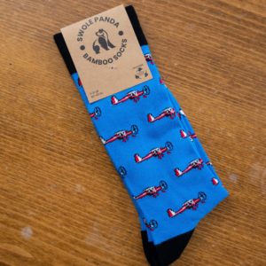 Swole Panda bamboo sock in pale blue with small red and white planes