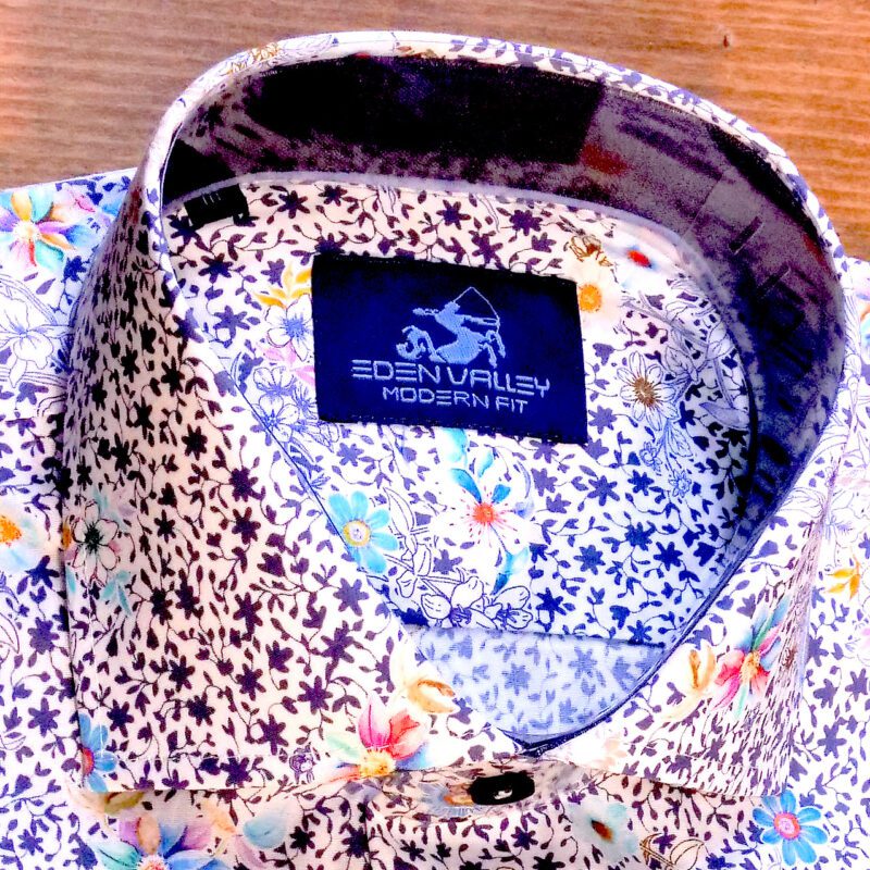 Eden Valley white shirt with small dark blue foliage and very colourful flowers