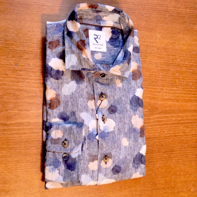 R2 grey shirt with large flower shapes in blue white brown and navy