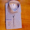 R2 white shirt with tiny white cups on brown saucers on a dark blue background