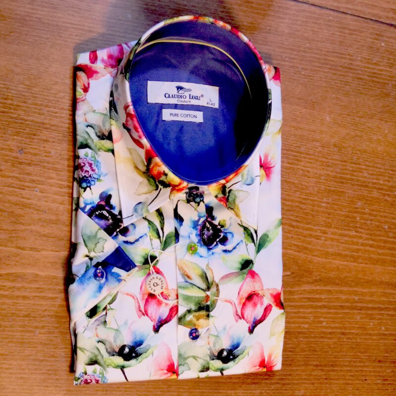Claudio Lugli white short sleeved shirt with large colourful flowers with a blue lining. The short sleeved shirts have all the flair of the full sleeved shirts but with a much more casual look.