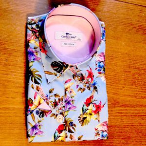 Claudio Lugli sky blue short sleeved shirt with large colourful flowers with a pink lining.