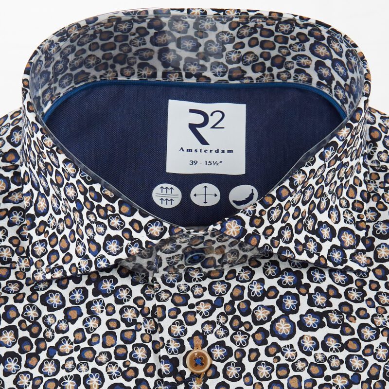 R2 white shirt with tiny blue and brown splodges with white flower outlines from Gabucci Bath