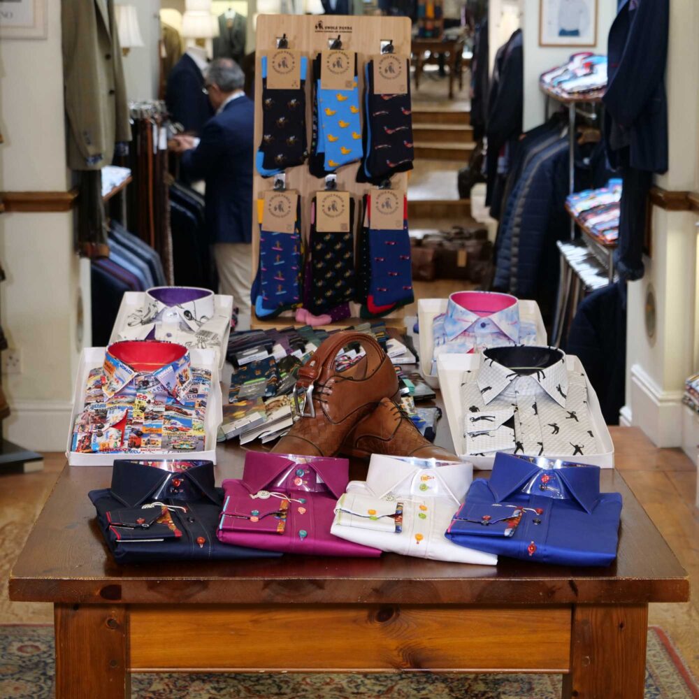 Display of shirts, suits and jumpers at Gabucci Menswear in Bath