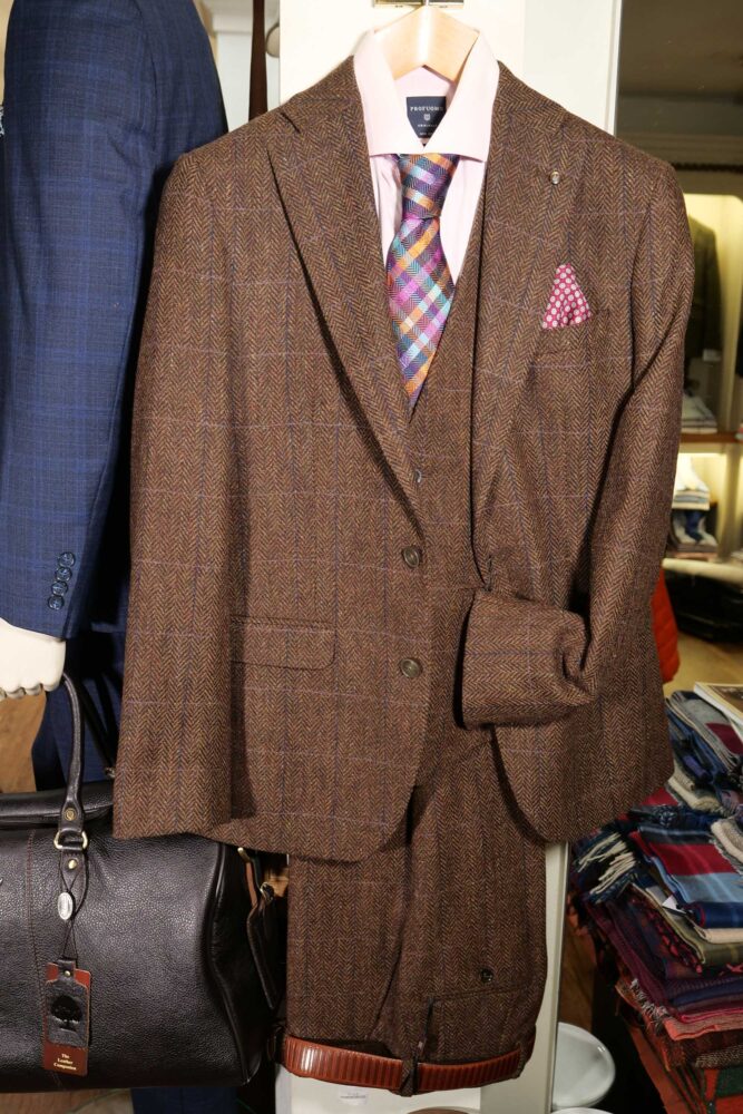 Display of shirts, suits and jumpers at Gabucci Menswear in Bath