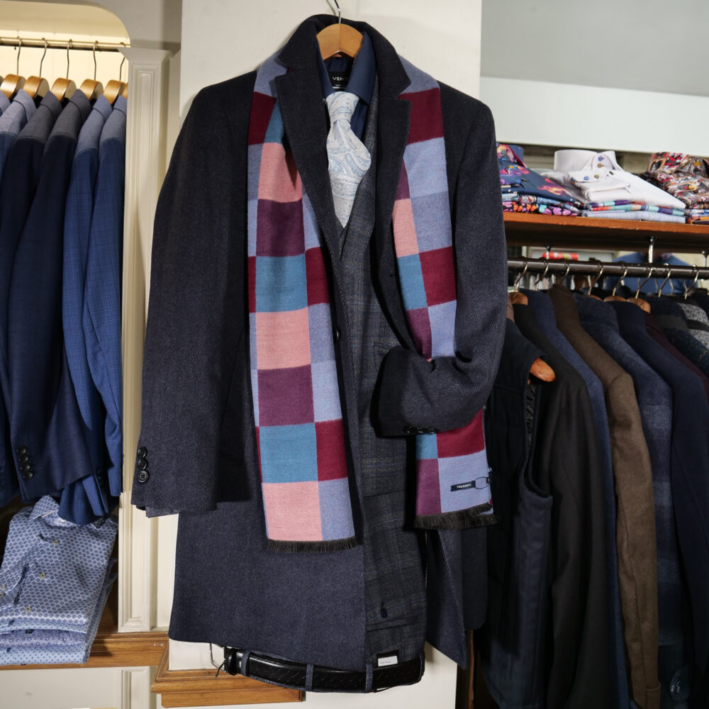 Display of shirts, suits and jumpers at Gabucci Menswear in Bath