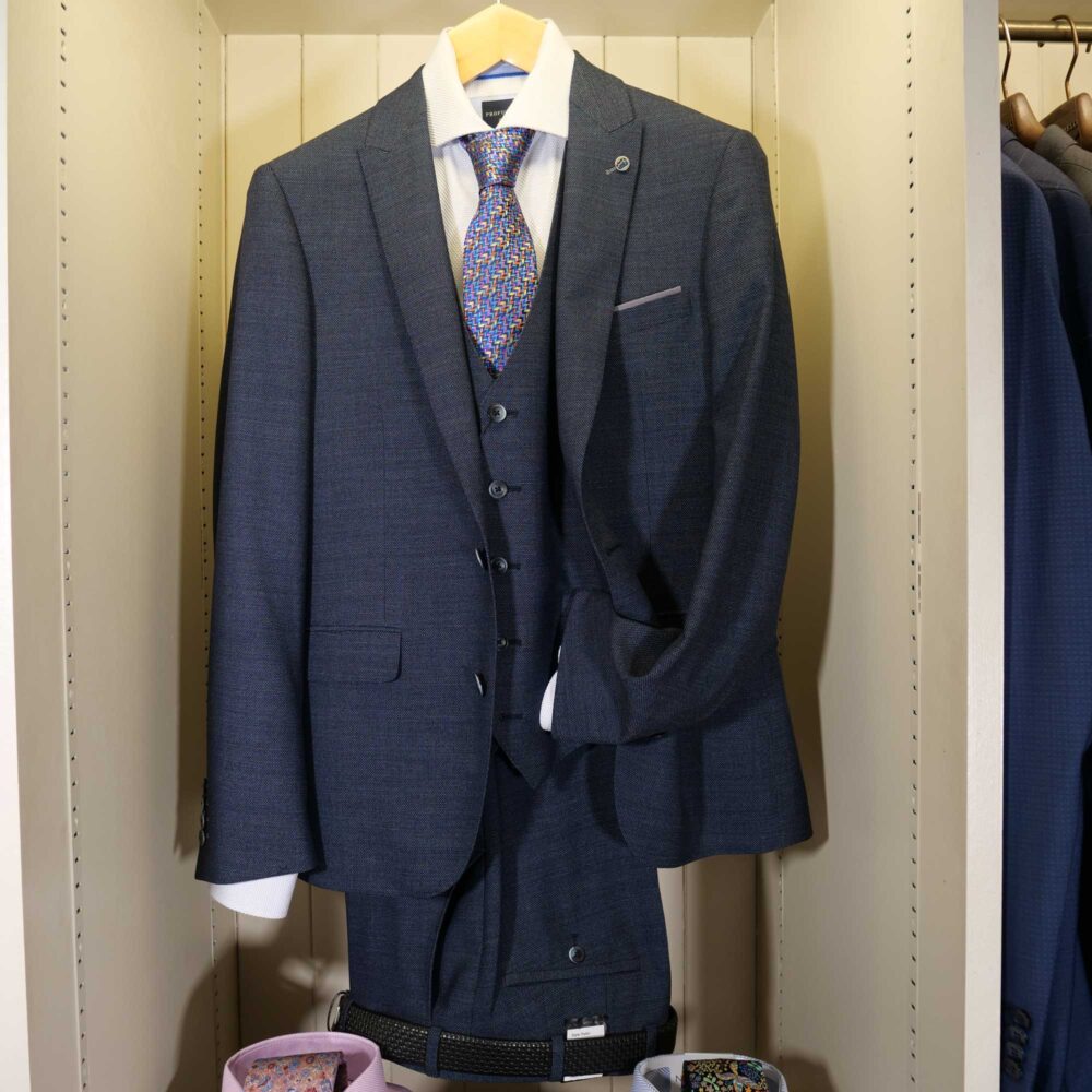 Display of shirts, suits and jumpers at Gabucci Menswear in Bath