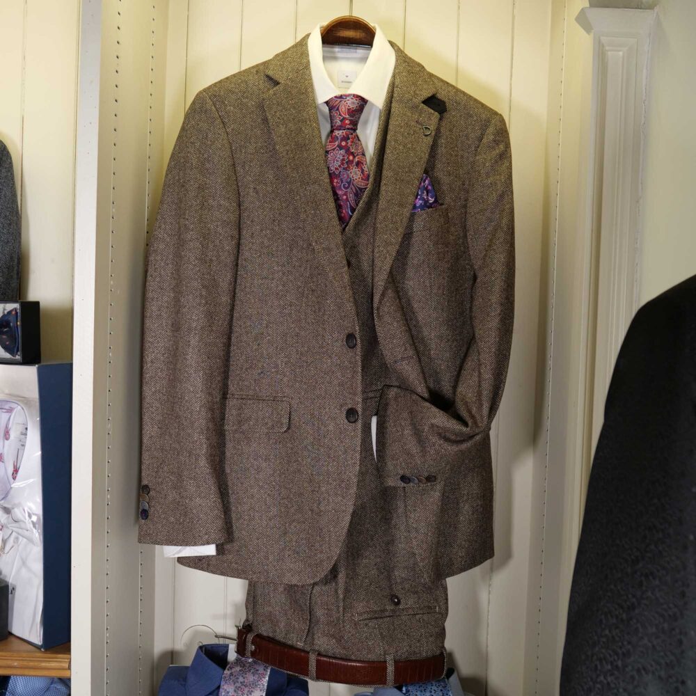 Display of shirts, suits and jumpers at Gabucci Menswear in Bath