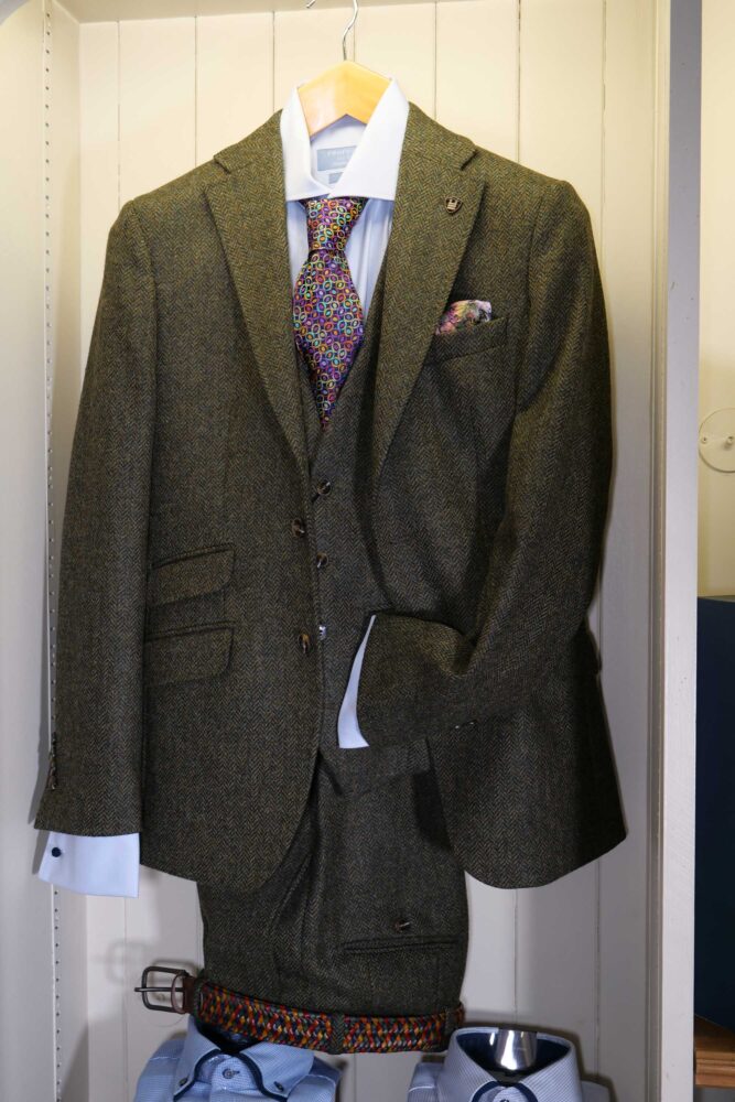 Display of shirts, suits and jumpers at Gabucci Menswear in Bath