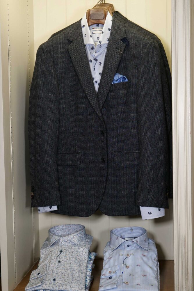 Display of shirts, suits and jumpers at Gabucci Menswear in Bath