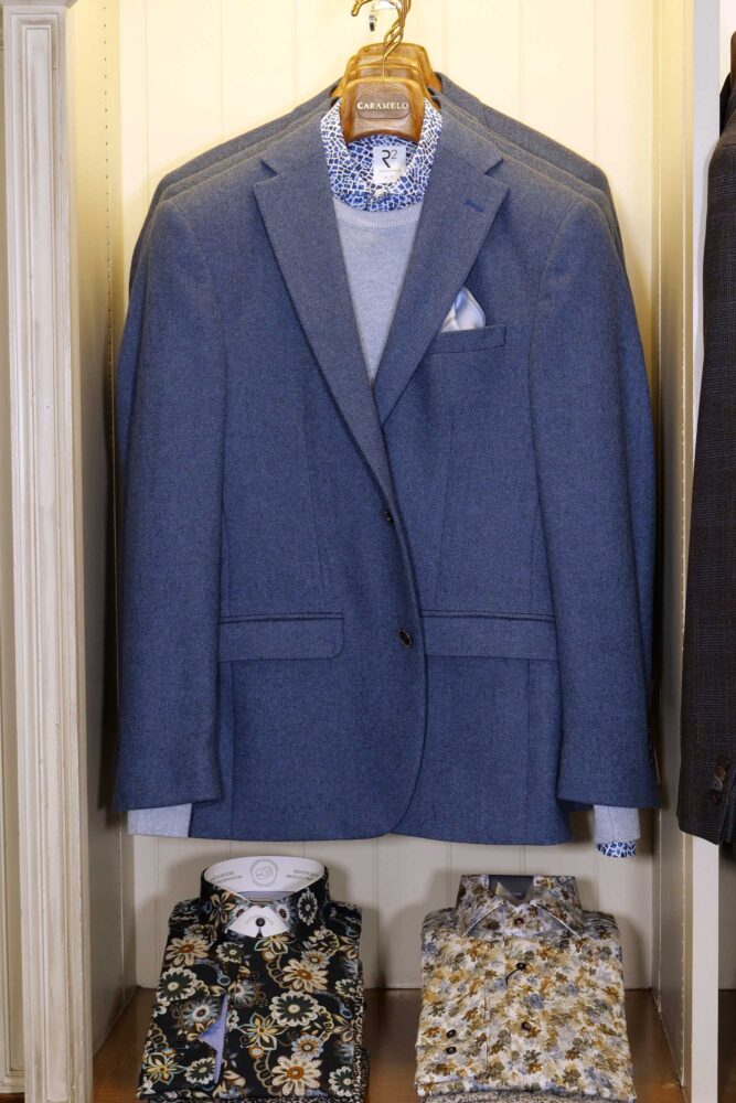 Display of shirts, suits and jumpers at Gabucci Menswear in Bath