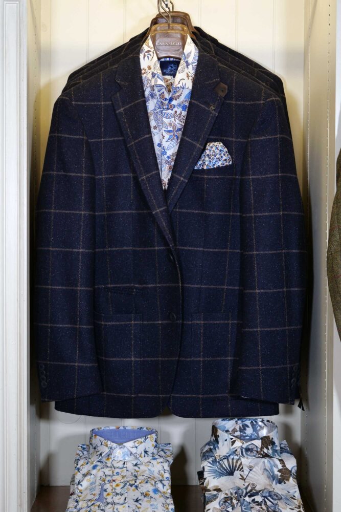 Display of shirts, suits and jumpers at Gabucci Menswear in Bath