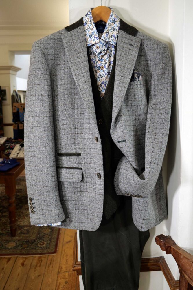 Display of shirts, suits and jumpers at Gabucci Menswear in Bath