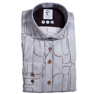 R2 blue shirt with brown lines creating powerful shapes reminiscent of stone cut figures