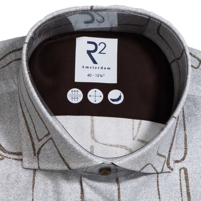 R2 blue shirt with brown lines creating powerful shapes reminiscent of stone cut figures