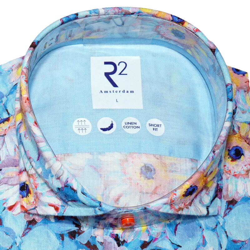 R2 pale blue shirt with large brightly coloured painted flowers. From Gabucci Menswear in Bath