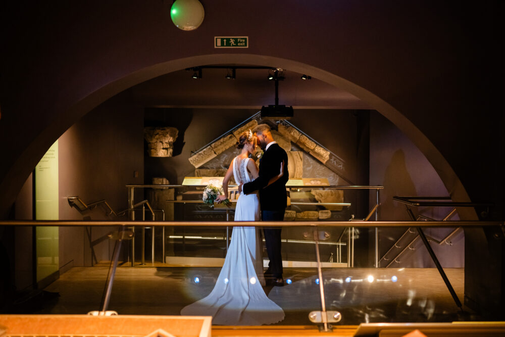 Image of wedding couple at the Royal Baths, Bath, the groom wears suit and shirt from Gabucci Menswear Bath, for Bath Royal Baths, shot by RICH HOWMAN & ELAN IMAGES LTD